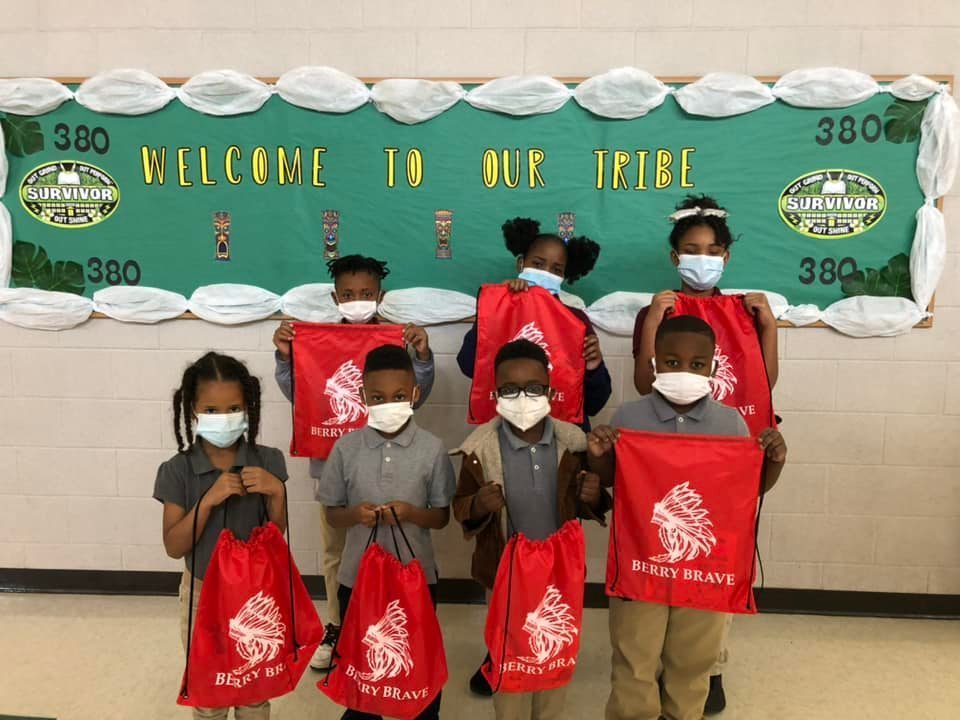 Students show off their bright red Berry Brave bags